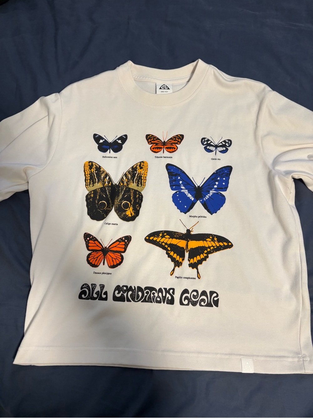 Nike ACG White Short Sleeve Tee with Multicolor Butterfly Graphics